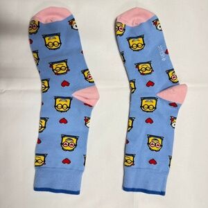 Light blue crew socks with a yellow character pattern- NEW in Bag,